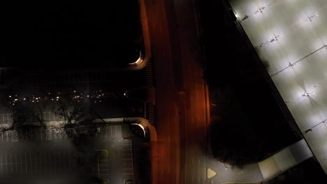 a top down view over an illuminated road at night