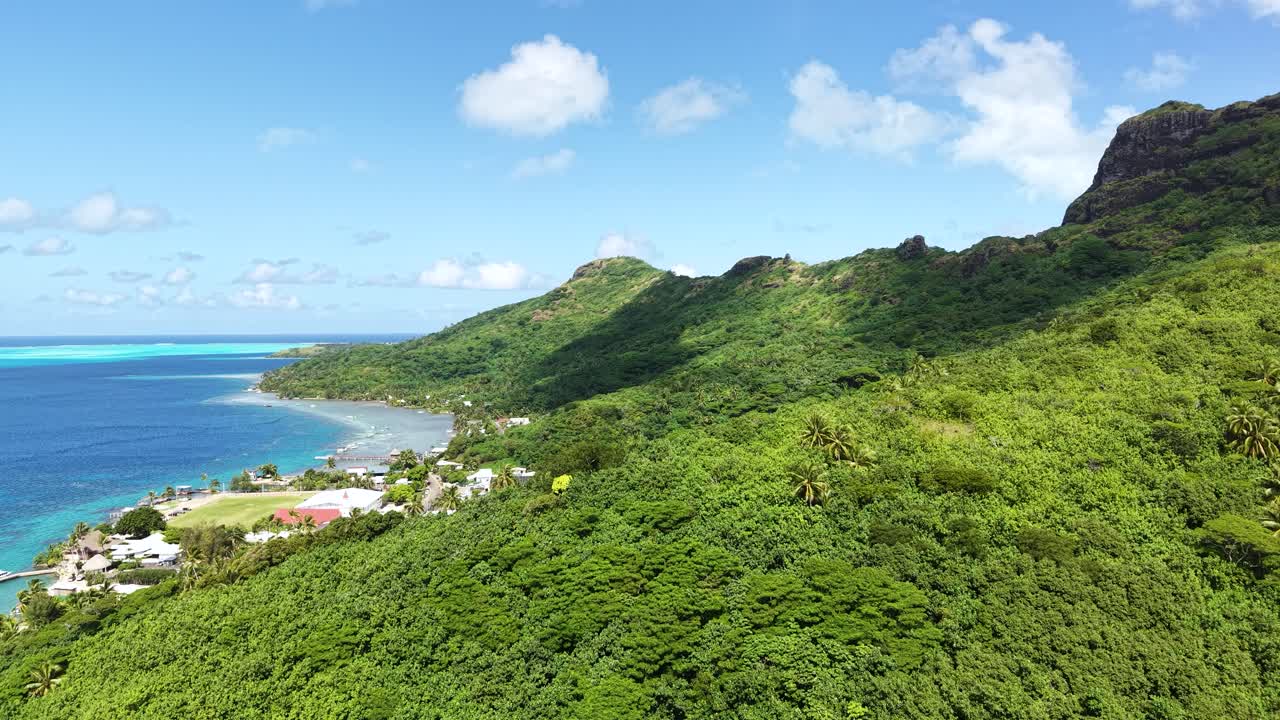 Drone Shot of Bora Bora Island, French Polynesia, Rainforest on Hills and Coastal Village