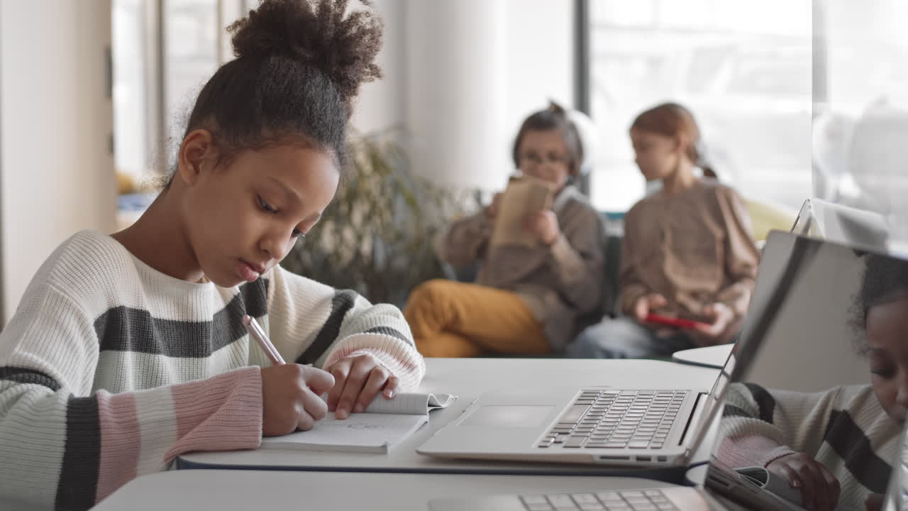 Afro American Schoolgirl Studying on Laptop in Class