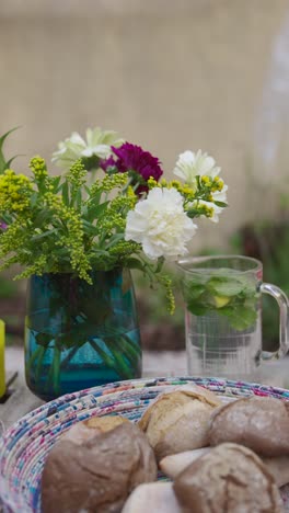 rustic outdoor table setting with flowers and bread