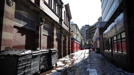 Snow-melting-in-a-city-back-street-on-a-sunny-day,-wide-angle,-Sheffield