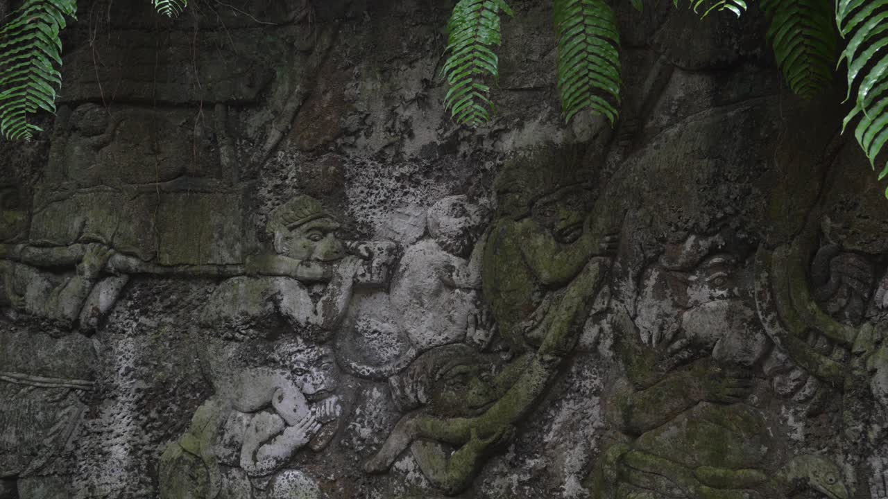 Balinese mythology sculpture carving in stone wall Bali Ubud Indonesia Southeast Asia