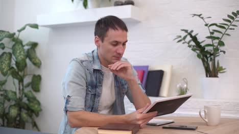 thoughtful serious young man student writer sit at home office desk with laptop thinking of inspiration search problem solution ideas lost in thoughts concept dreaming looking away