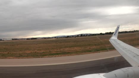 Plane-Take-of-Off-at-Tarmac-Runway,-Passenger-POV-View-Through-Window