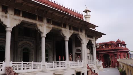 ancient-artistic-holy-jain-temple-with-holy-pillar-and-cloudy-sky-at-morning-video-is-taken-at-Soni-Ji-Ki-Nasiya-Jain-Temple,-Ajmer,-Rajasthan,-India