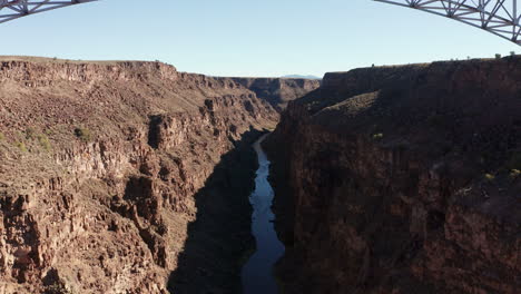 Rising-aerial-as-cars-drive-across-large-bridge-over-Rio-Grande-river-gorge