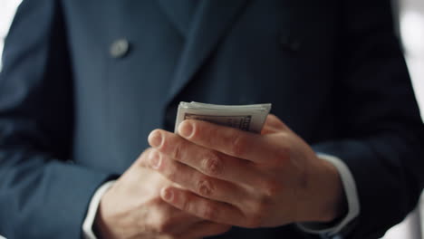 Man-hands-holding-dollar-bills-close-up.-Businessman-having-pack-currency.