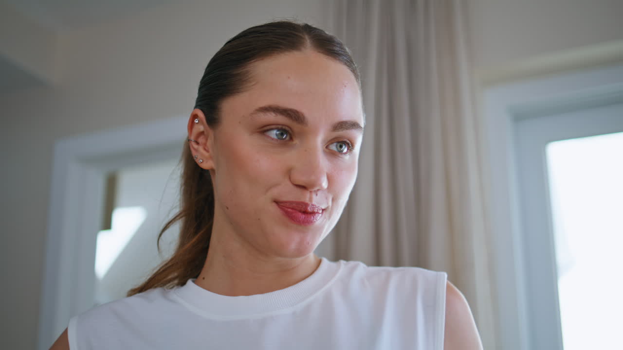 Relaxed woman drinking water indoors to stay hydrated closeup. girl
