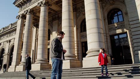 father and daughter in front of a historical building