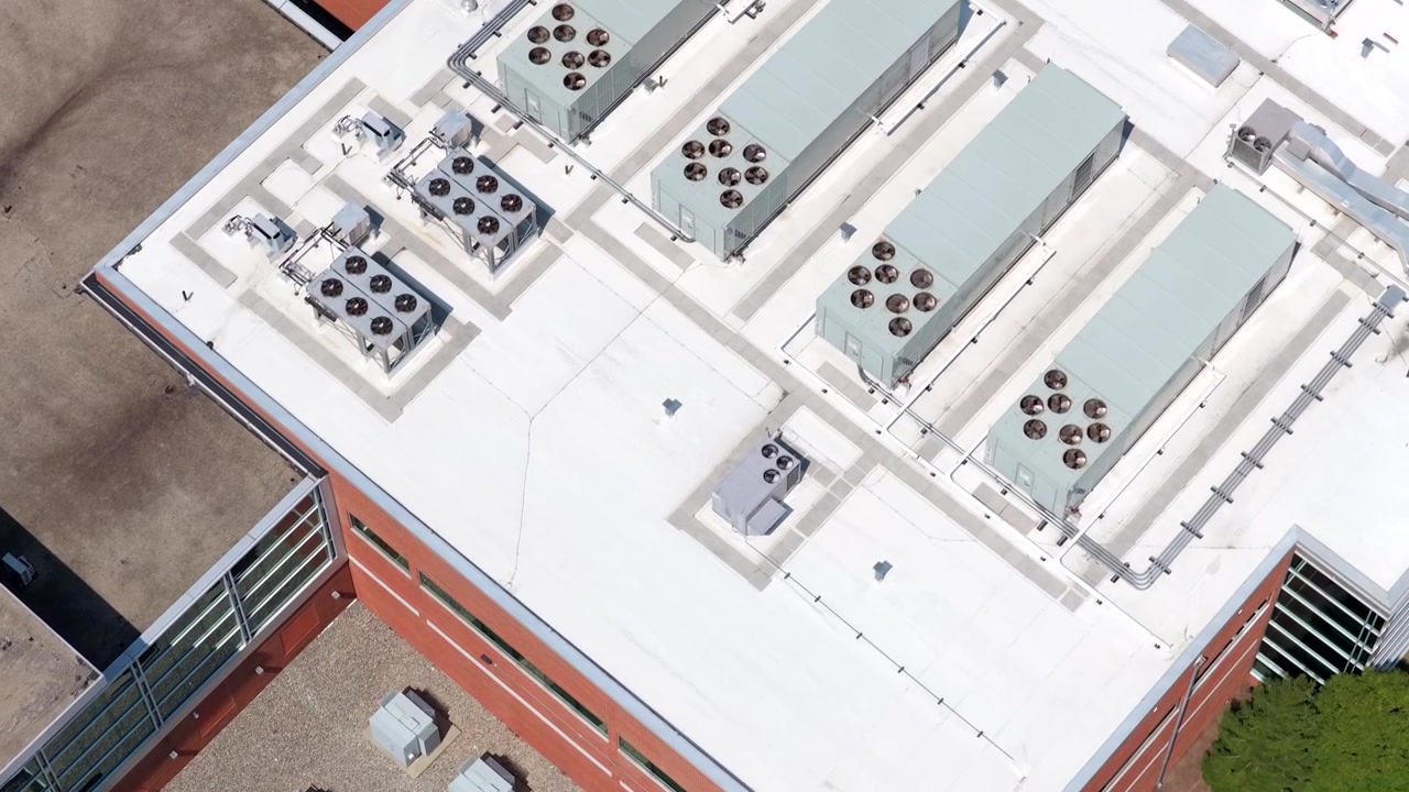 Air-handling, ventilation systems and utility connections installed on a modern data center. Infrastructure that helps regulate airflow, temperature and humidity