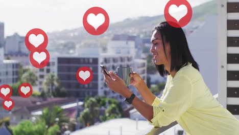 animation of social media red heart icons over biracial woman using smartphone