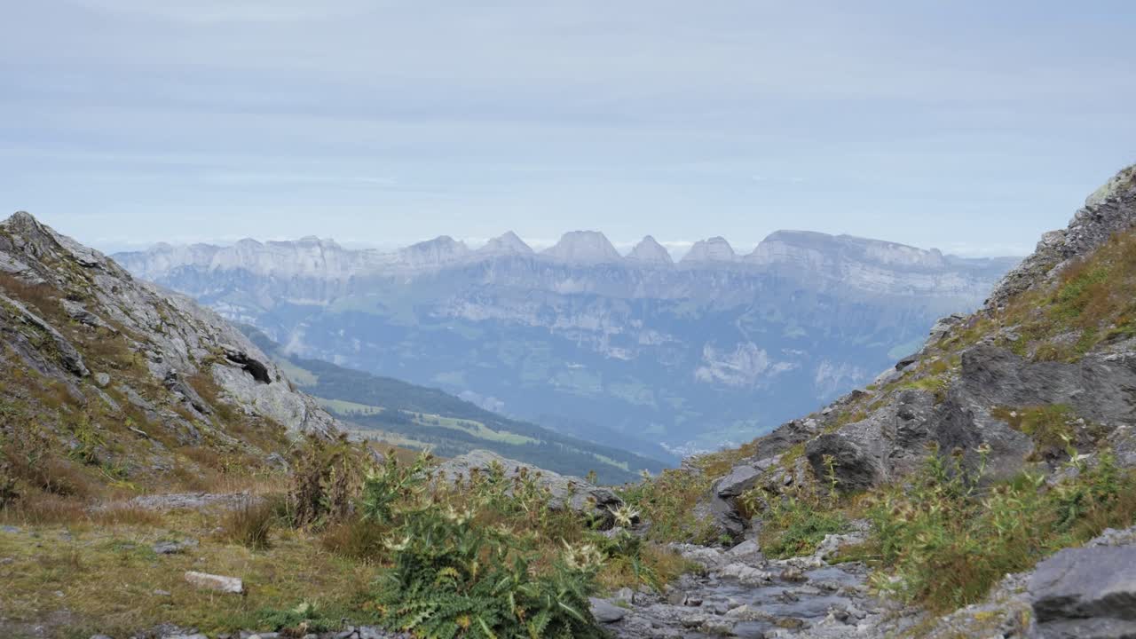 Pizol mountain valley with alps in perspective, static shot