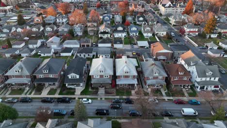 aerial view of a residential street with rows of gabled houses during autumn