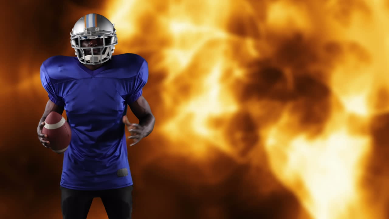 Giocatore di football americano che tiene la palla su fiamme
