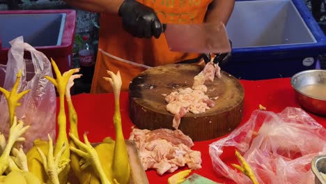 preparing chicken at a street market