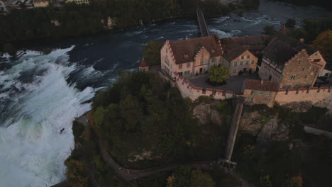 aerial shot over the castle of laufen
and where you can see the falls of the rhine river and the bridge that crosses it