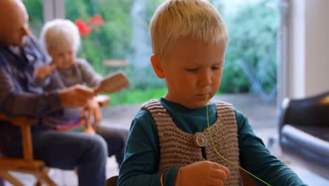 Boy-holding-thread-and-sewing-needle-at-home-4k