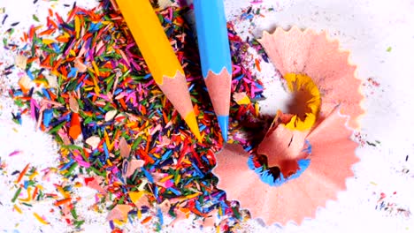 blue and yellow pencils on pile of leftovers