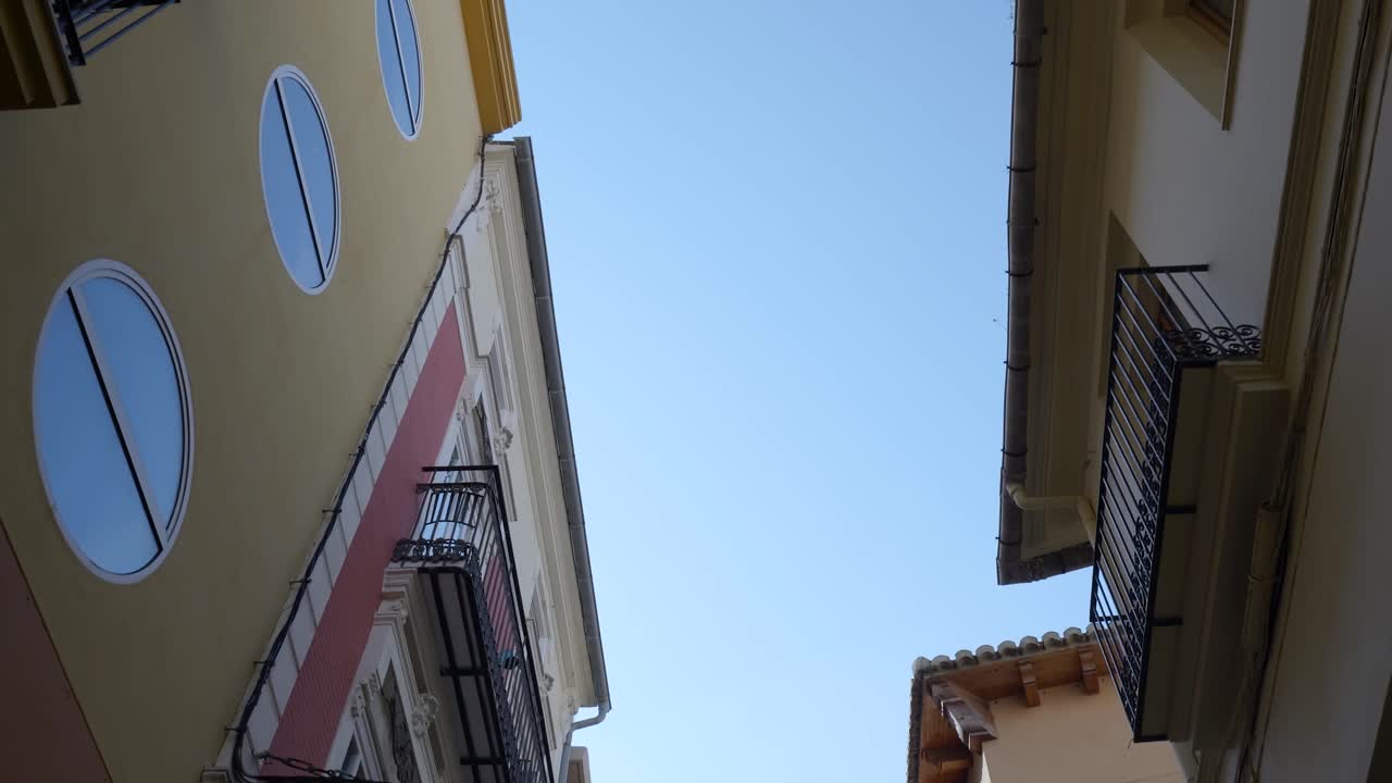 Narrow City Alleyway with Buildings and Balconies