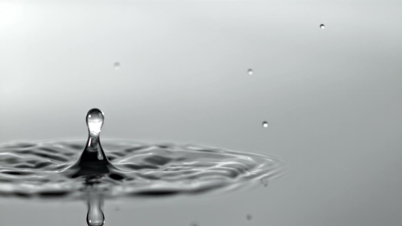 Slow Motion Water Drop Creating a Crown Splash and Ripples
