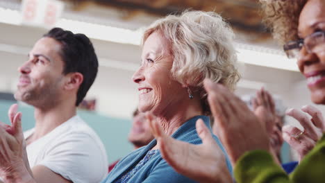 Group-Attending-Neighborhood-Meeting-In-Community-Center-Clapping