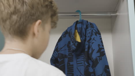 person looking at clothes in a closet