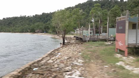 left moving trucking shot of a abandoned derelict destroyed bungalow beach resort in koh chang, thailand, from the effects of covid 19 on tourism