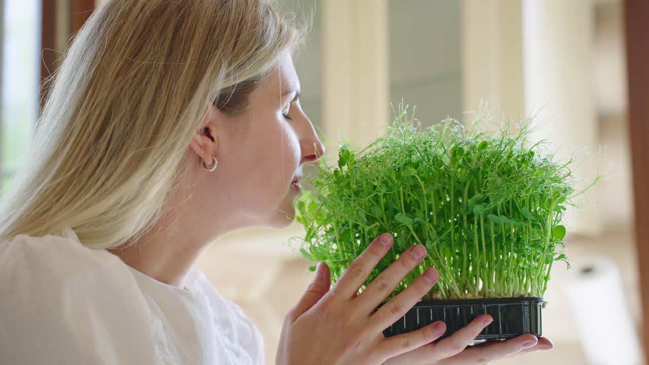 Woman Holding Fresh Pea Sprouts