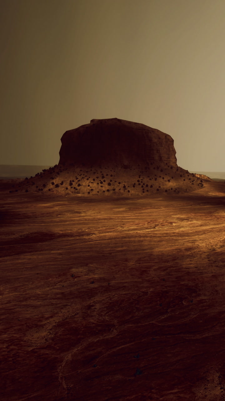 Desert landscape with rock formation during sunset near a distant horizon