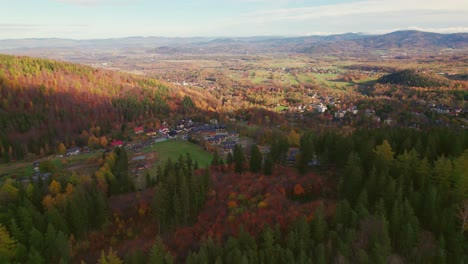 karpacz, poland, autumn drone tilt-up view of a mountain city well lit