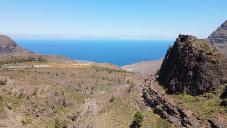 tamadaba natural park, tirma: aerial view passing near large rock formations in this natural park on the island of gran canaria on a sunny day