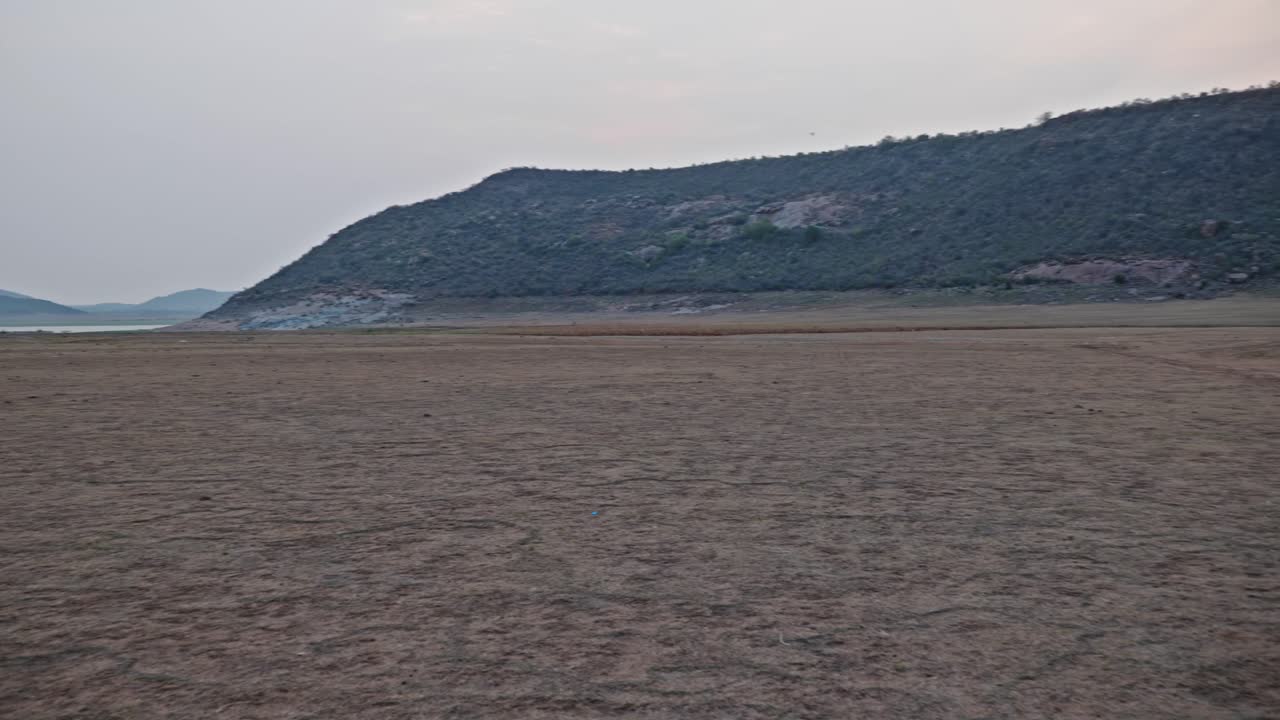 big hill mountain with sand and sky at nagarjuna sagar backwater, vizag colony, azmapur, nalgonda district, telangana, andhra pradesh, india. day time, pan shot, 4k.