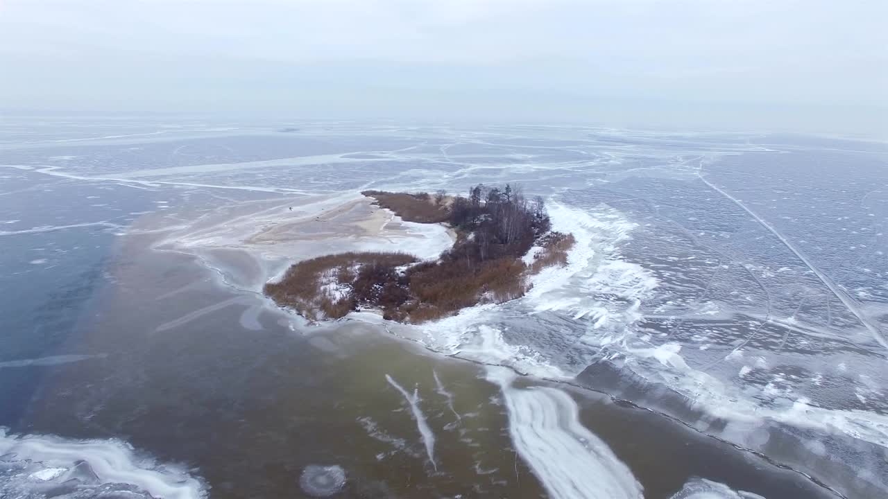 4K Aerial. Winter Landscape, fly around  small island in frozen sea .