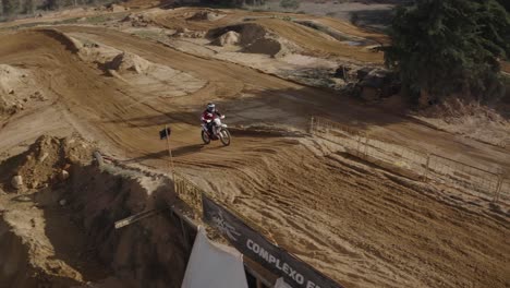 skilled motocross rider on a sandy track performing