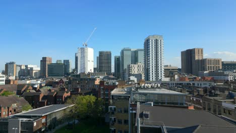 drone shot suburban town with skyscraper developments in england