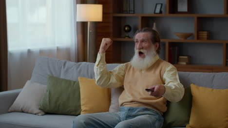 excited senior man watching tv