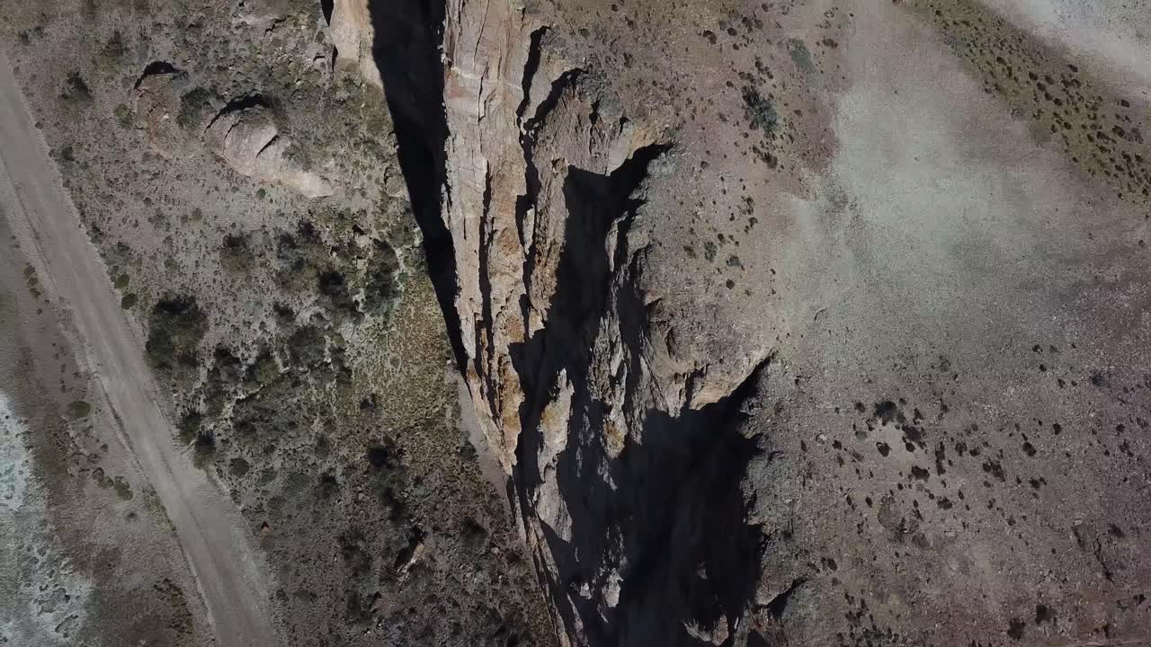 Birds Eye Aerial View of Steep Canyon With Salt Flat and Road, Patagonia, Argentina
