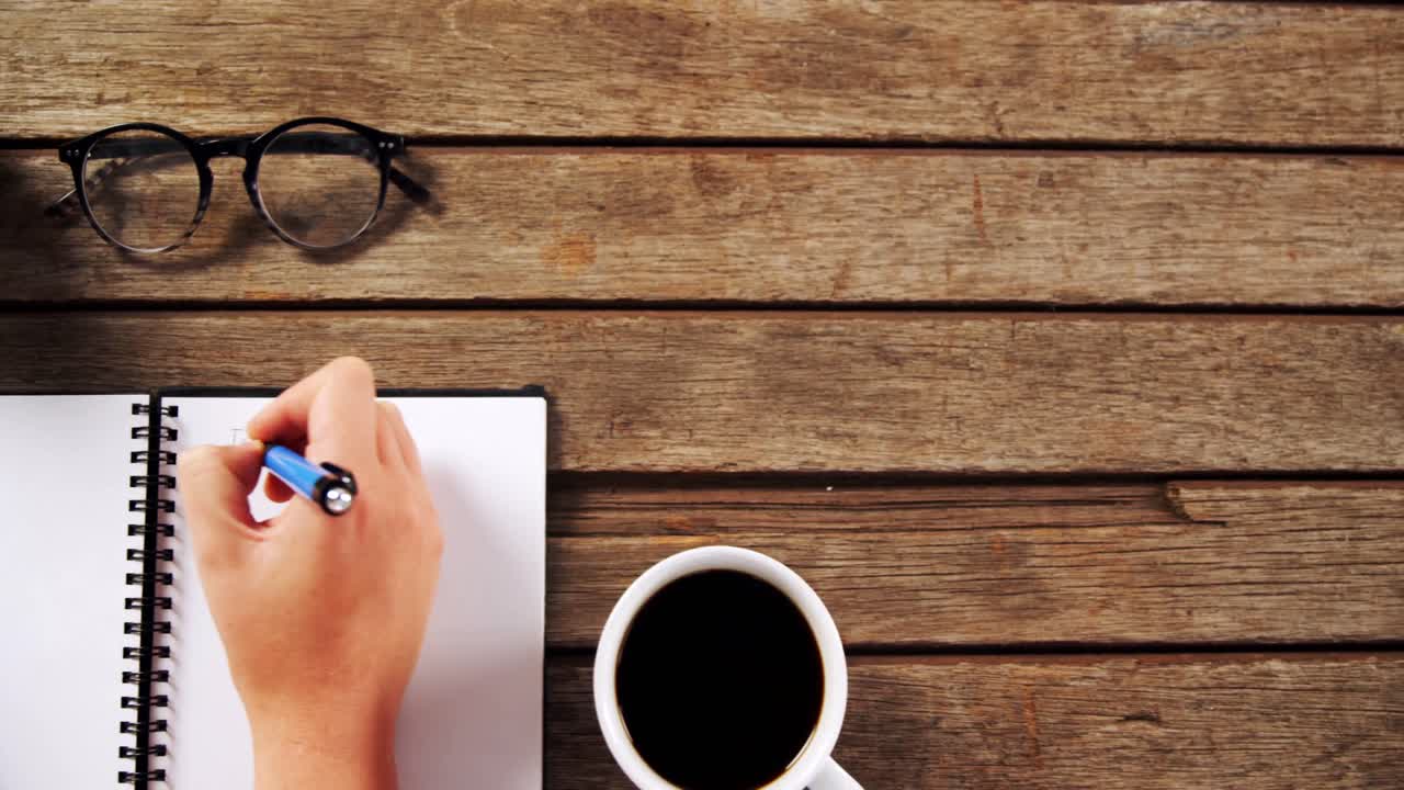 Executive writing in organizer at office 4k