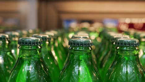 close-up of green glass bottles with caps