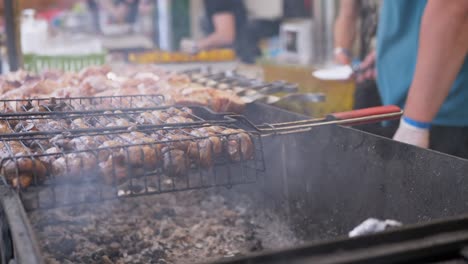 street chef prepares juicy grilled vegetables, mushrooms outdoor in food court