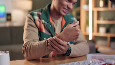 man experiencing wrist pain at his desk