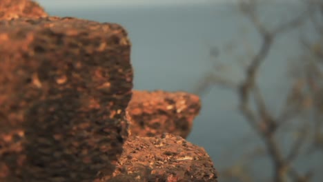 beautiful view of the indian ocean and a orange pealed rock