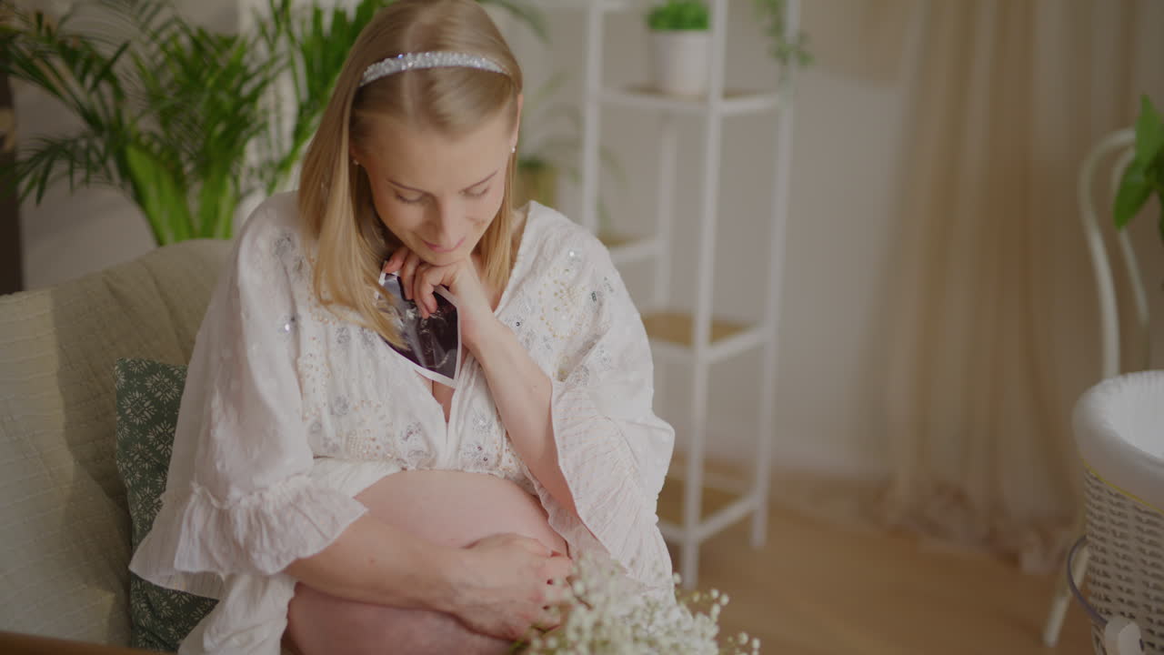 Pregnant Woman Embracing Ultrasound Photo