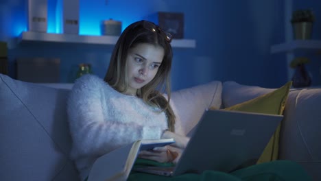 Young-college-student-woman-studying-at-home-at-night.