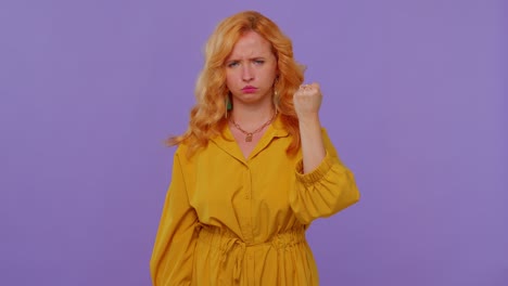 aggressive angry girl trying to fight at camera, shaking fist, boxing with expression, punishment