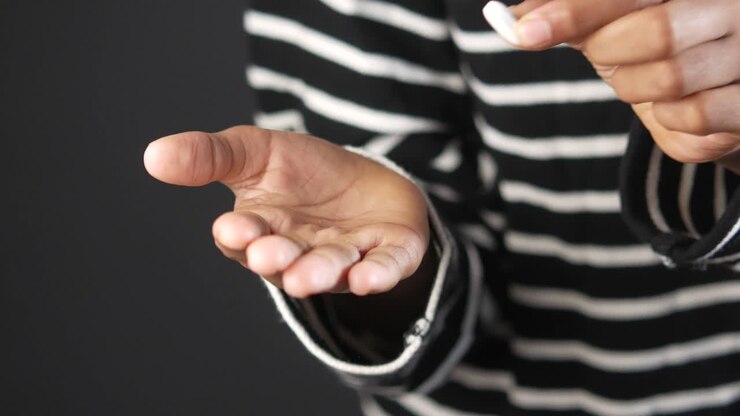 Person Holding a Pill
