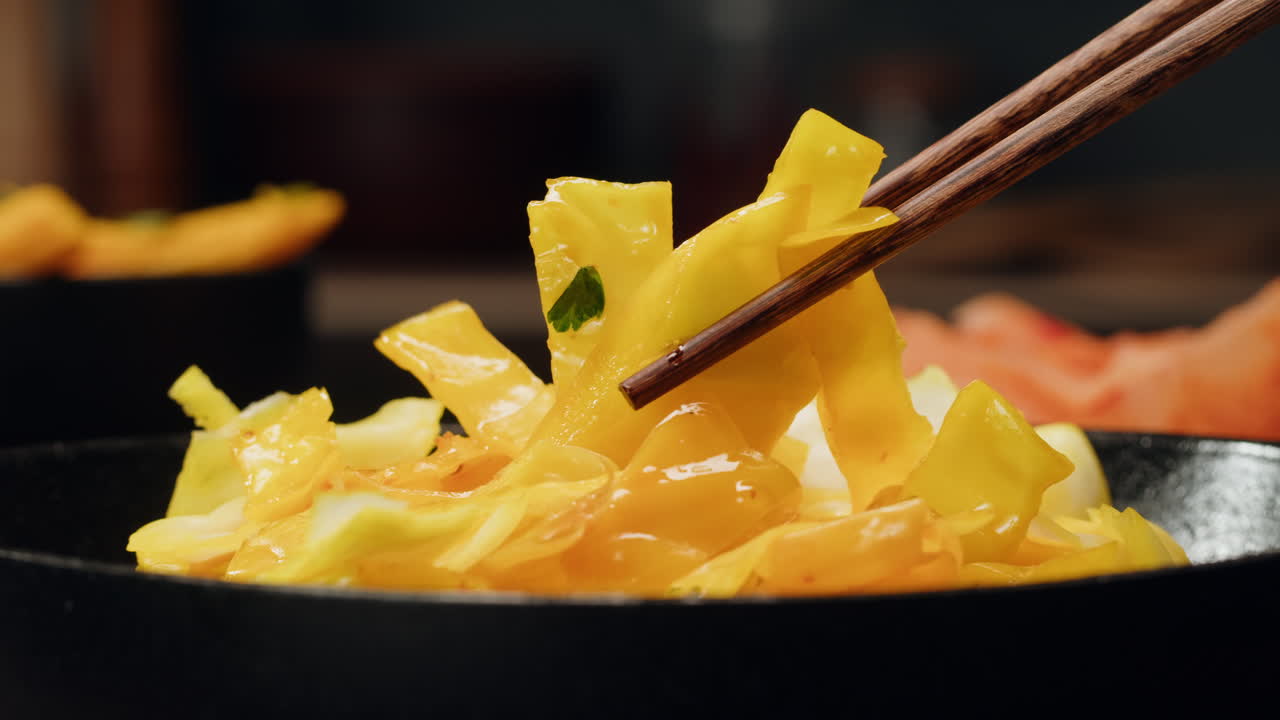 Close-up of fermented yellow cabbage on plate. Preservation of vegetables in glass jars. Fermentation preserved vegetables. Sauerkraut with spices.