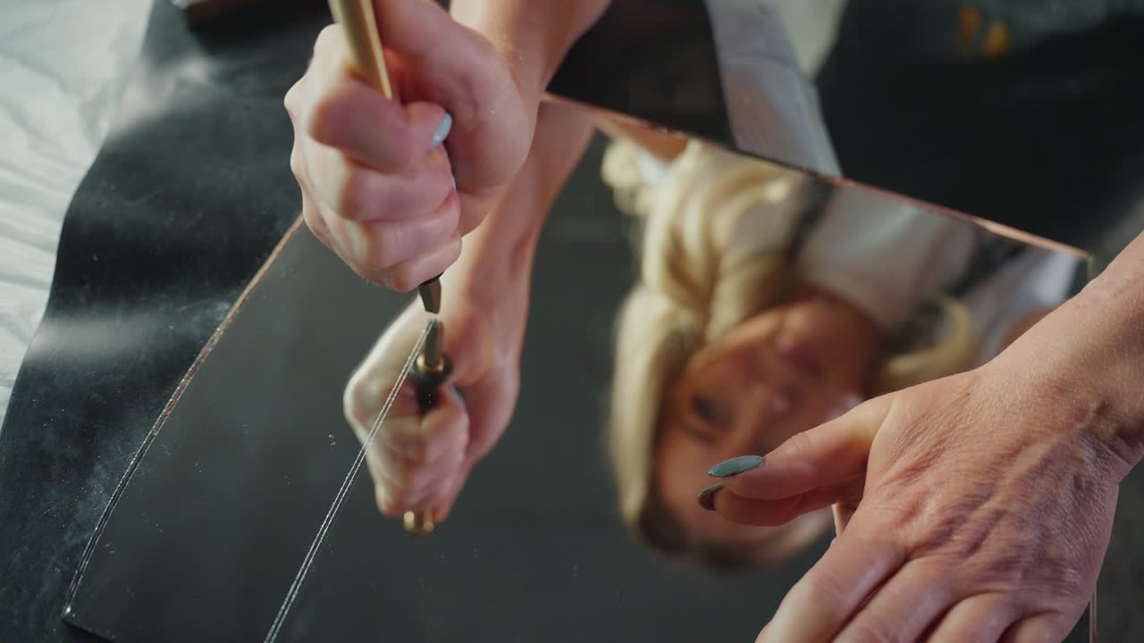 Woman Cutting a Mirror