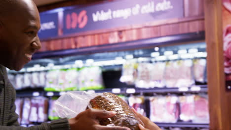 smiling female staff giving a goods to customer