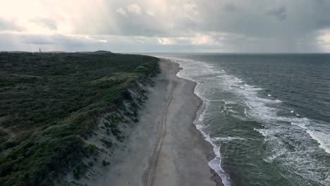 aerial view of a remote, sandy beach in holland on a cloudy day